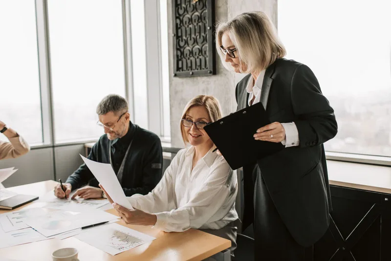 Équipe échangeant des documents pendant une réunion de travail
